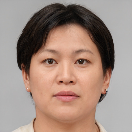 Neutral asian adult female with short  brown hair and brown eyes