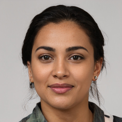 Joyful latino young-adult female with medium  black hair and brown eyes