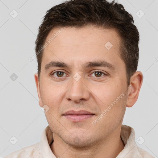 Joyful white adult male with short  brown hair and brown eyes