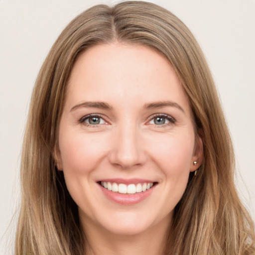 Joyful white young-adult female with long  brown hair and green eyes