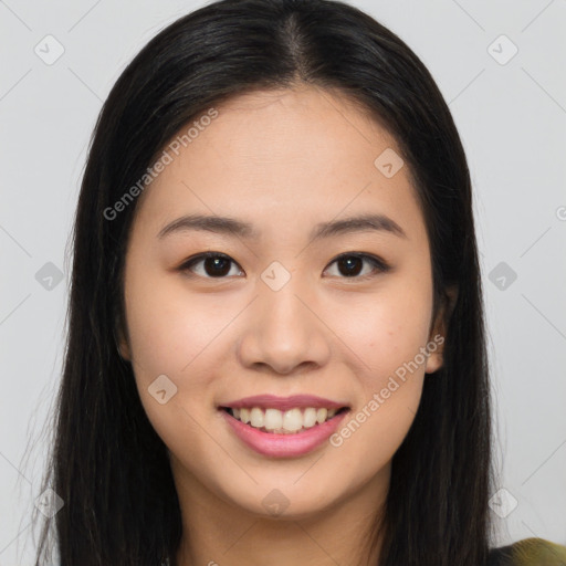 Joyful asian young-adult female with long  brown hair and brown eyes