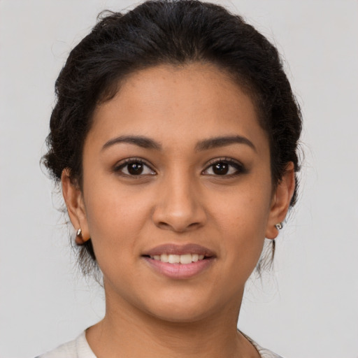 Joyful latino young-adult female with short  brown hair and brown eyes