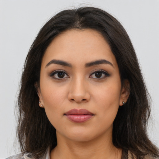 Neutral latino young-adult female with long  brown hair and brown eyes