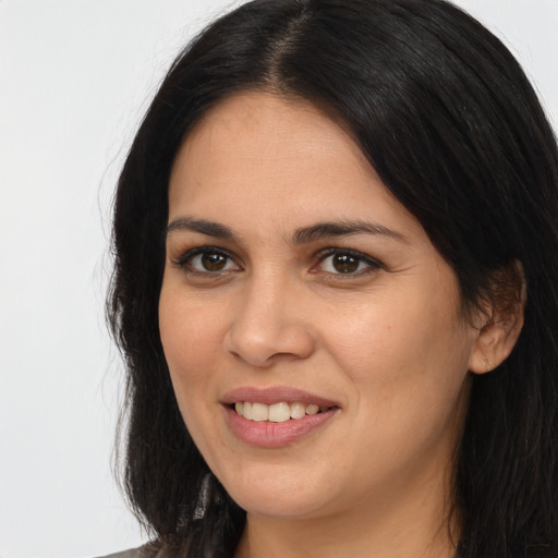 Joyful white young-adult female with long  black hair and brown eyes