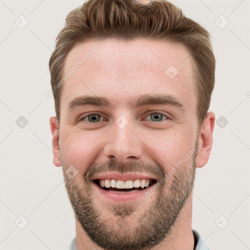 Joyful white young-adult male with short  brown hair and grey eyes