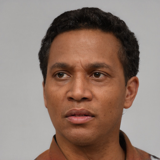 Neutral latino adult male with short  black hair and brown eyes