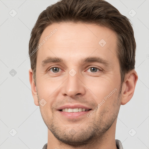 Joyful white young-adult male with short  brown hair and brown eyes