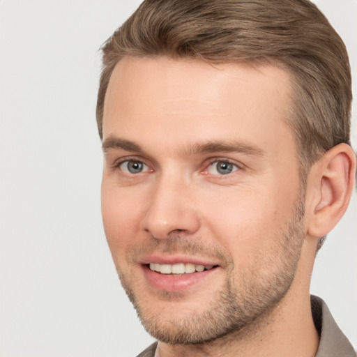 Joyful white young-adult male with short  brown hair and brown eyes