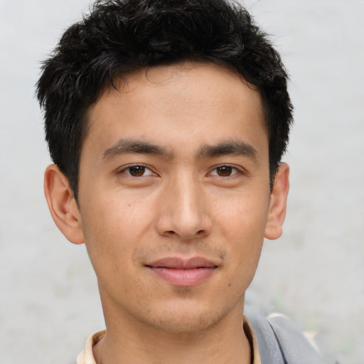 Joyful asian young-adult male with short  brown hair and brown eyes