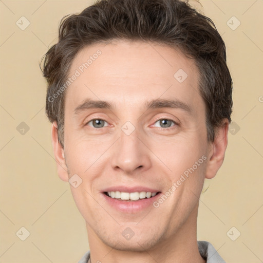 Joyful white adult male with short  brown hair and brown eyes