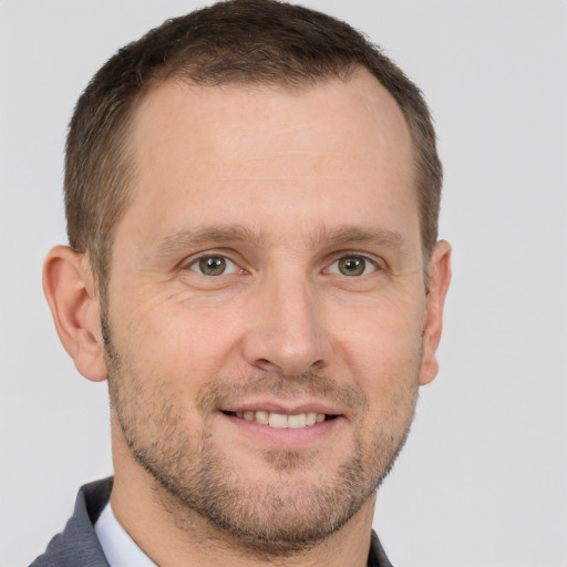 Joyful white adult male with short  brown hair and grey eyes