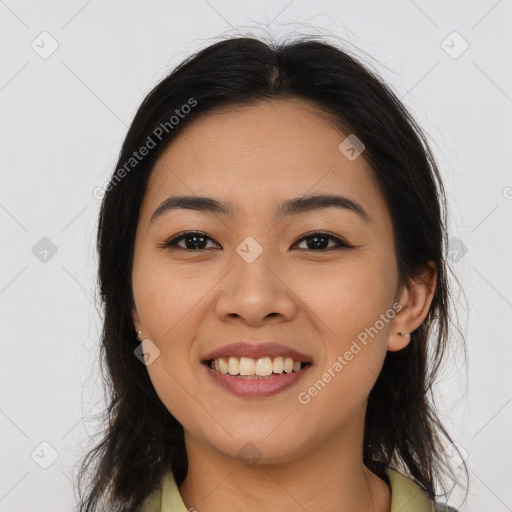 Joyful latino young-adult female with long  brown hair and brown eyes