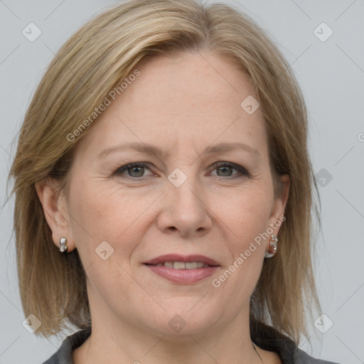 Joyful white adult female with medium  brown hair and grey eyes