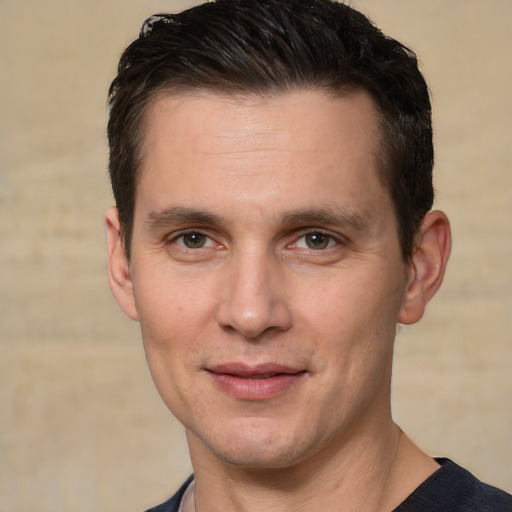 Joyful white young-adult male with short  brown hair and brown eyes