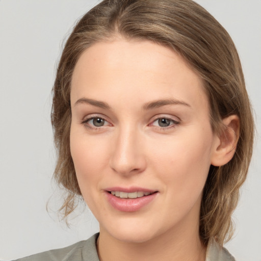 Joyful white young-adult female with medium  brown hair and grey eyes