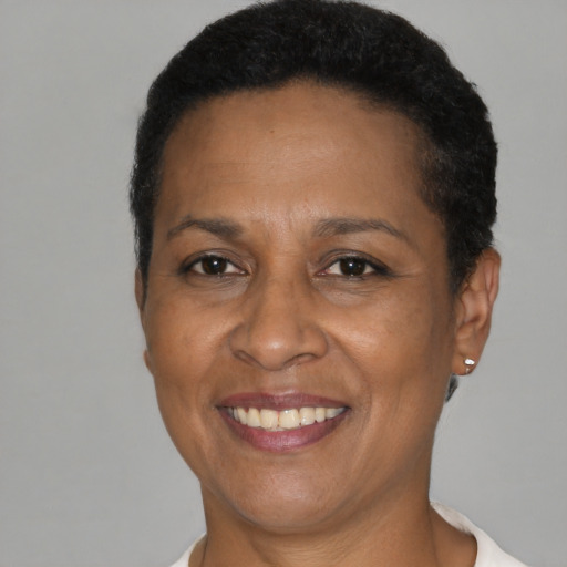 Joyful black adult female with short  brown hair and brown eyes