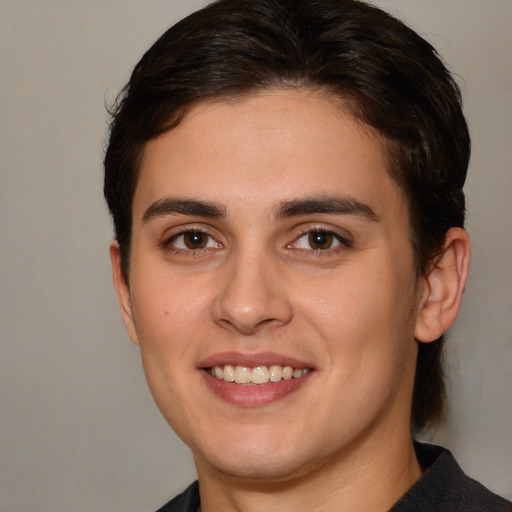 Joyful white young-adult male with medium  brown hair and brown eyes