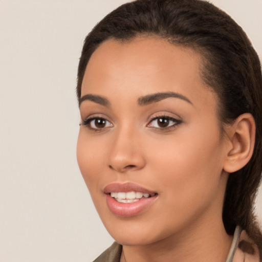 Joyful latino young-adult female with medium  brown hair and brown eyes