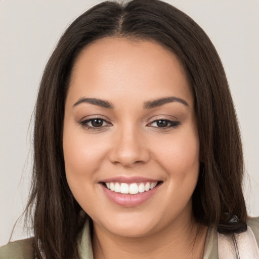 Joyful white young-adult female with long  brown hair and brown eyes