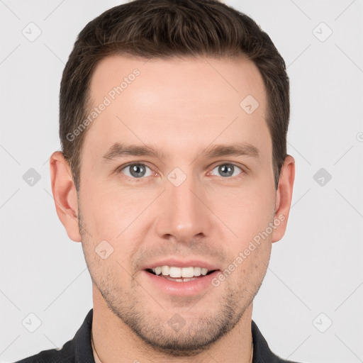 Joyful white young-adult male with short  brown hair and grey eyes