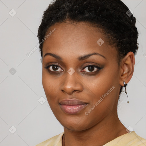 Joyful black young-adult female with short  black hair and brown eyes