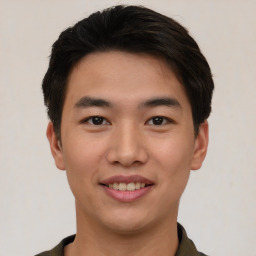 Joyful asian young-adult male with short  black hair and brown eyes