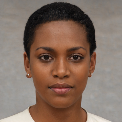 Joyful black young-adult female with short  black hair and brown eyes