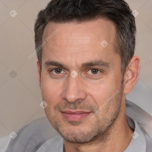 Joyful white adult male with short  brown hair and brown eyes