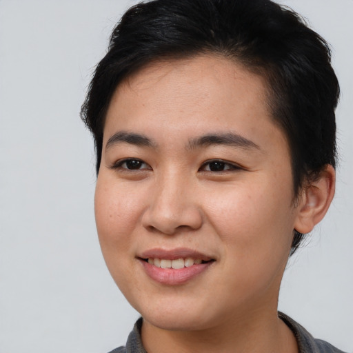Joyful asian young-adult female with short  brown hair and brown eyes