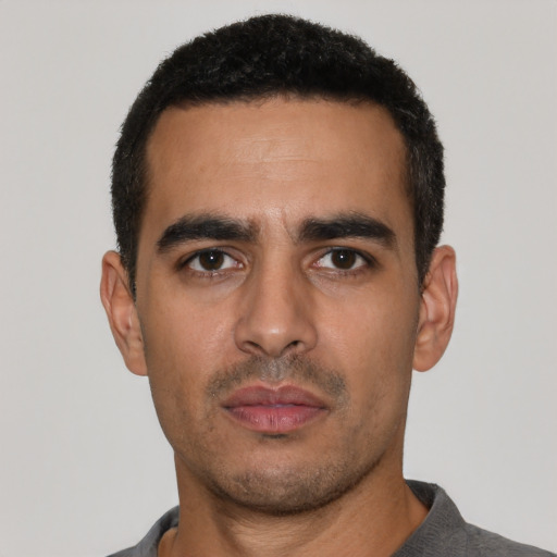 Neutral latino young-adult male with short  black hair and brown eyes