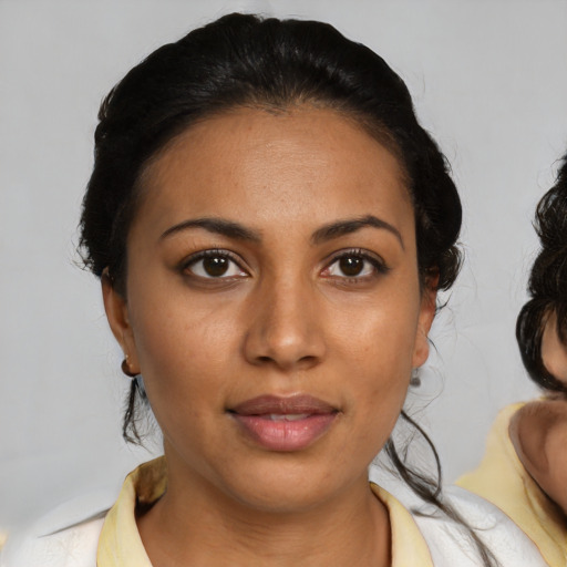 Joyful latino young-adult female with medium  black hair and brown eyes