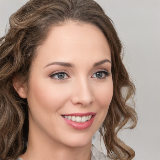 Joyful white young-adult female with long  brown hair and green eyes