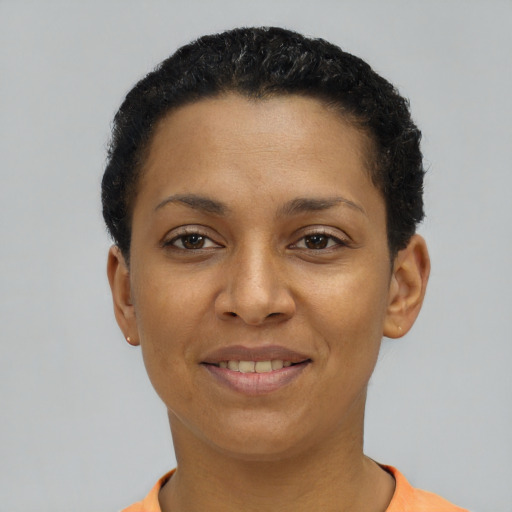 Joyful latino young-adult female with short  black hair and brown eyes