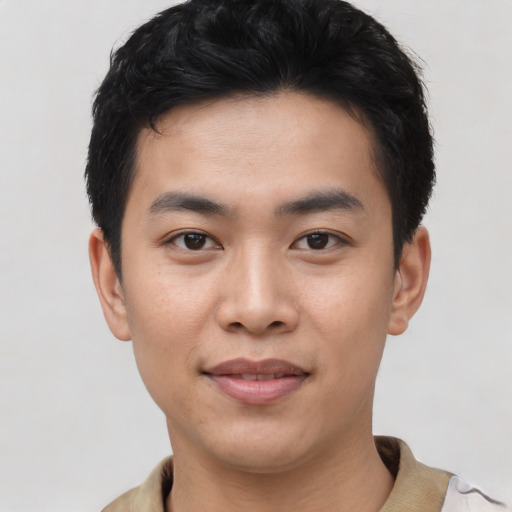 Joyful asian young-adult male with short  black hair and brown eyes