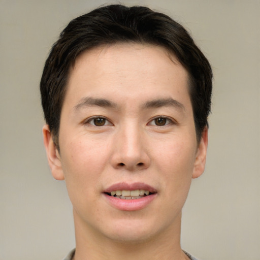 Joyful asian young-adult male with short  brown hair and brown eyes