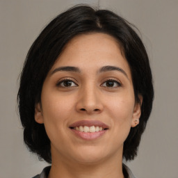 Joyful latino young-adult female with medium  brown hair and brown eyes