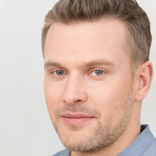 Joyful white adult male with short  brown hair and grey eyes