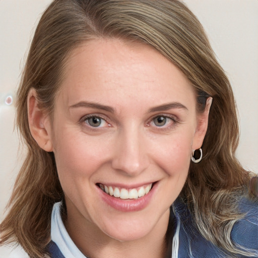 Joyful white young-adult female with medium  brown hair and blue eyes