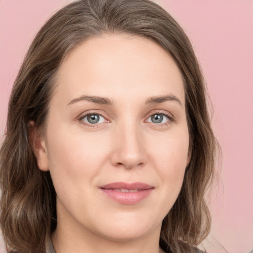 Joyful white young-adult female with medium  brown hair and green eyes