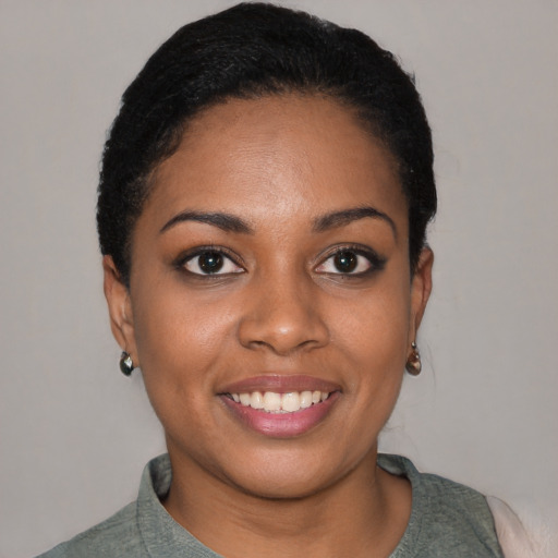 Joyful black young-adult female with short  black hair and brown eyes