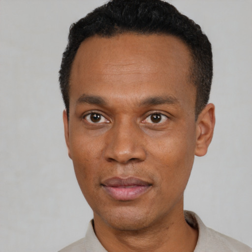 Neutral black adult male with short  black hair and brown eyes
