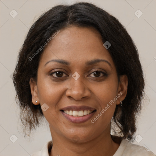 Joyful black adult female with medium  brown hair and brown eyes