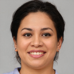 Joyful latino young-adult female with medium  brown hair and brown eyes