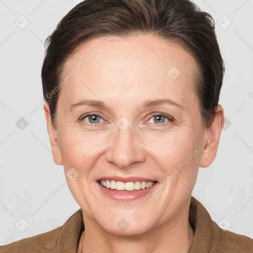 Joyful white adult female with short  brown hair and grey eyes