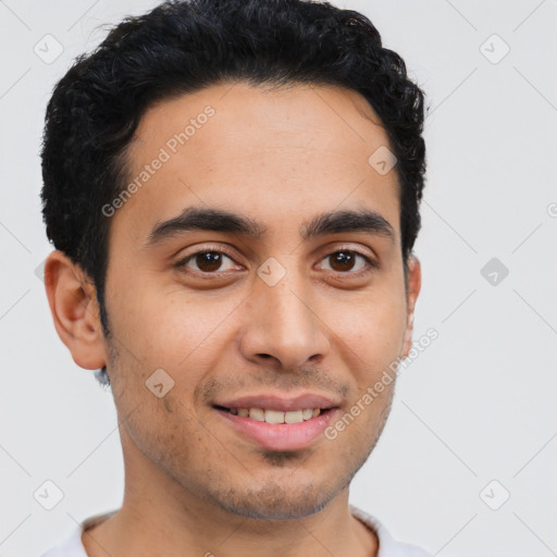 Joyful latino young-adult male with short  brown hair and brown eyes