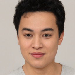 Joyful asian young-adult male with short  black hair and brown eyes