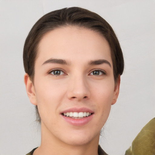 Joyful white young-adult female with short  brown hair and brown eyes