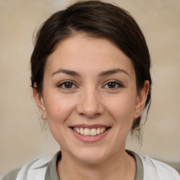 Joyful white young-adult female with medium  brown hair and brown eyes