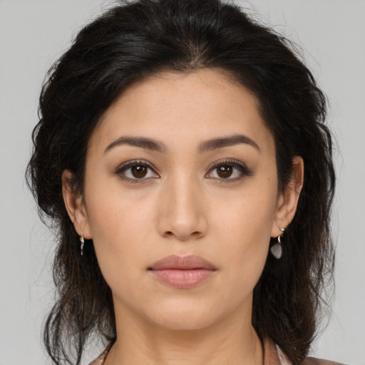 Neutral latino young-adult female with long  brown hair and brown eyes