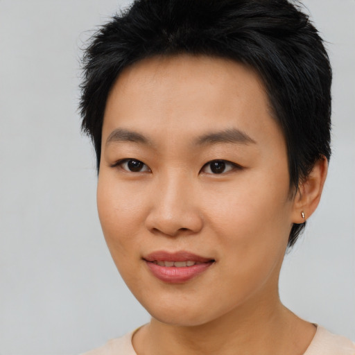 Joyful asian young-adult female with short  black hair and brown eyes